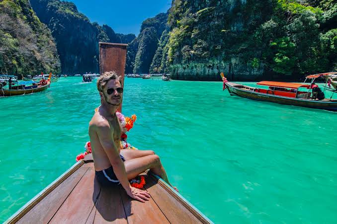 Thailand island lagoon with longtail boat