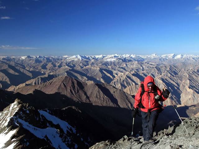 Traveler among snow-capped Ladakh mountains