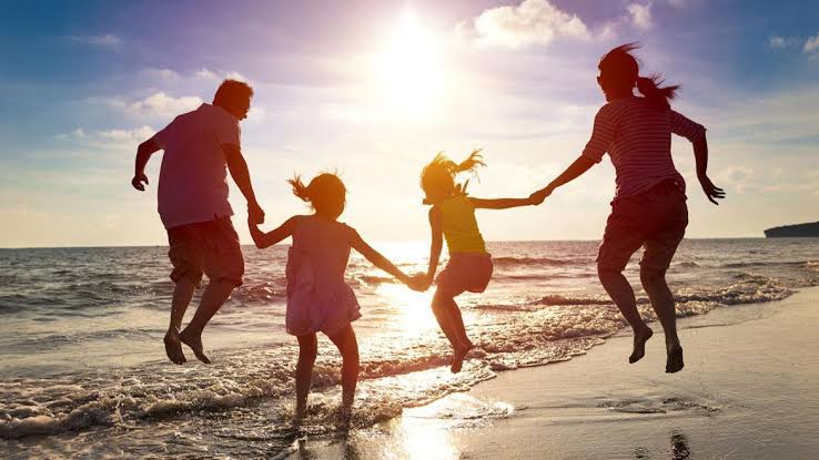 Family playing together on the beach