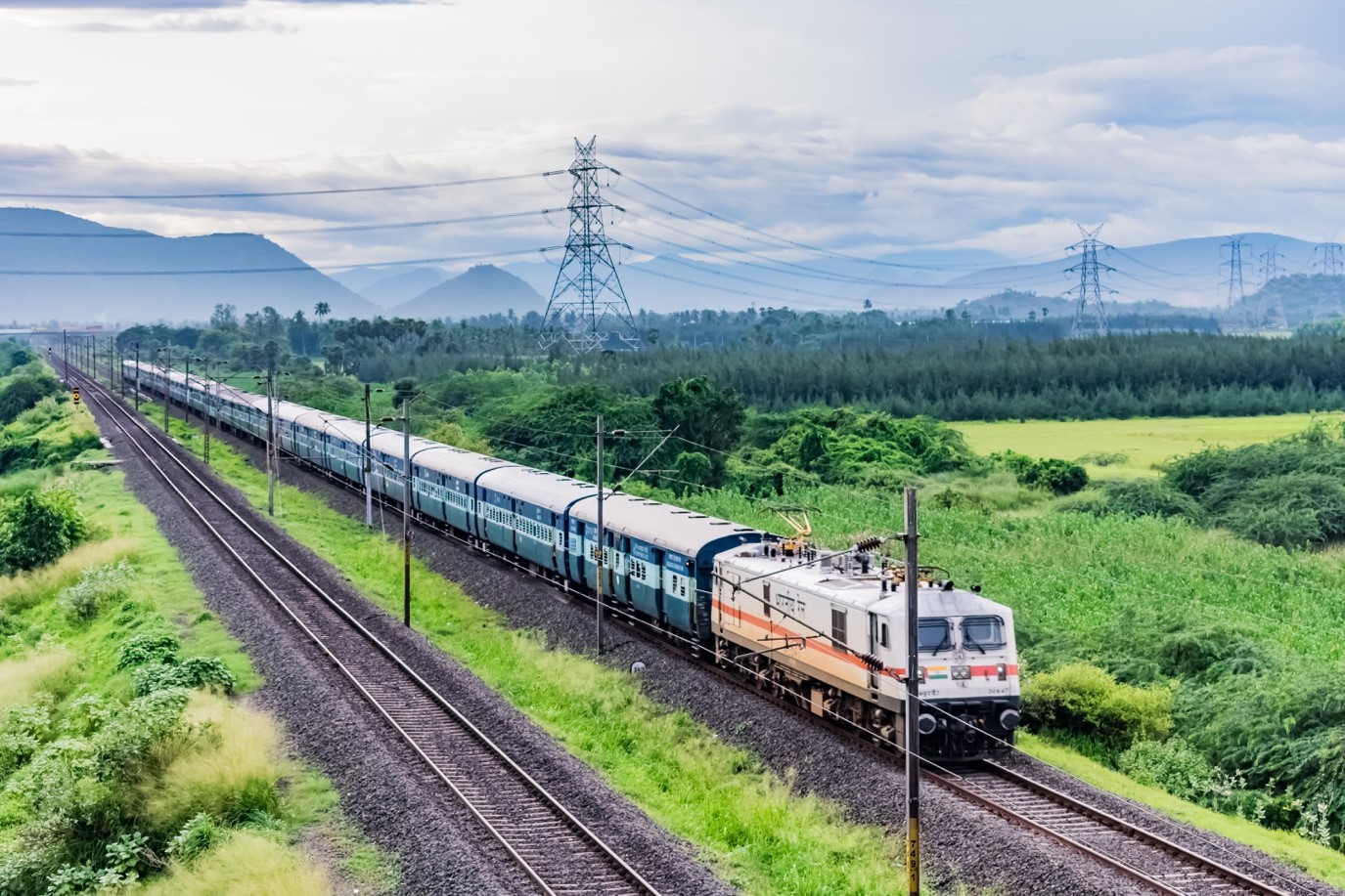 Train travelling through green hills